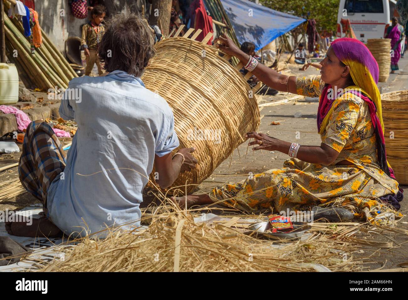 Indian people making wicker basket on the street in Dharavi Slum at Mumbai.  India Stock Photo - Alamy