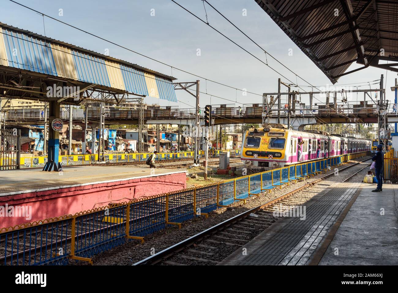 Local train arriving at railway station. Mumbai Suburban Railway. India Stock Photo