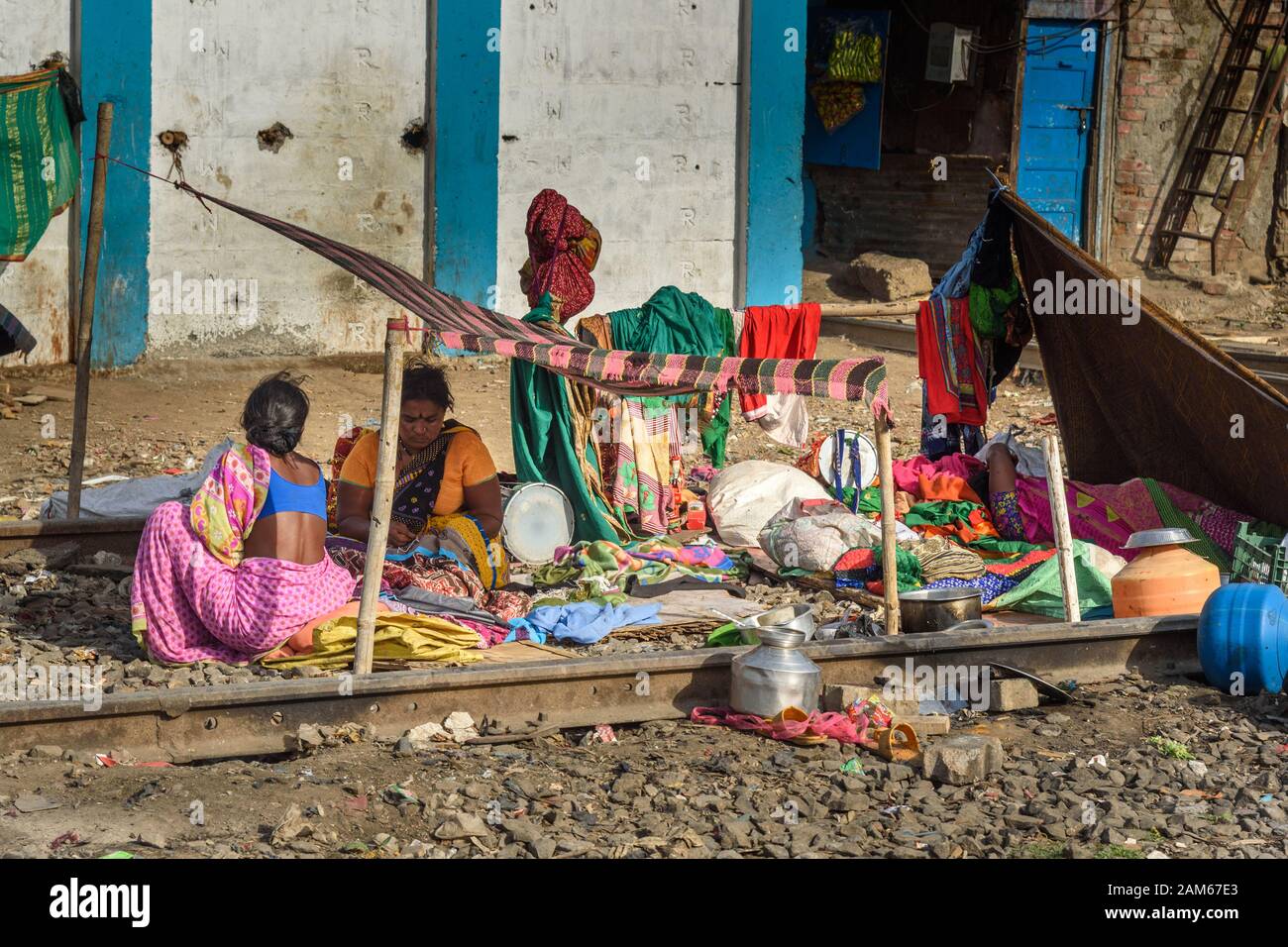 Indian poor people live near Suburban Railway in Dharavi Slum at Mumbai. India Stock Photo