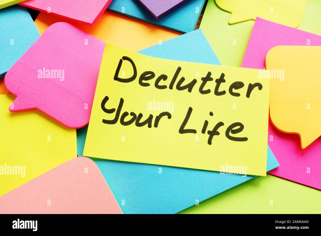 Declutter your life written by hand on the sheet. Stock Photo