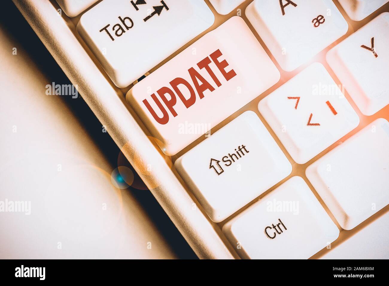 Conceptual hand writing showing Update. Concept meaning by adding new information or making corrections Up to date White pc keyboard with note paper a Stock Photo