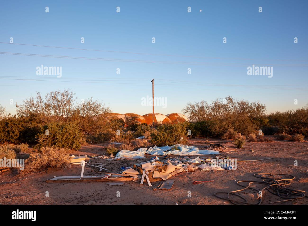 Trash illegally dumped in the Arizona desert near abandoned dome
