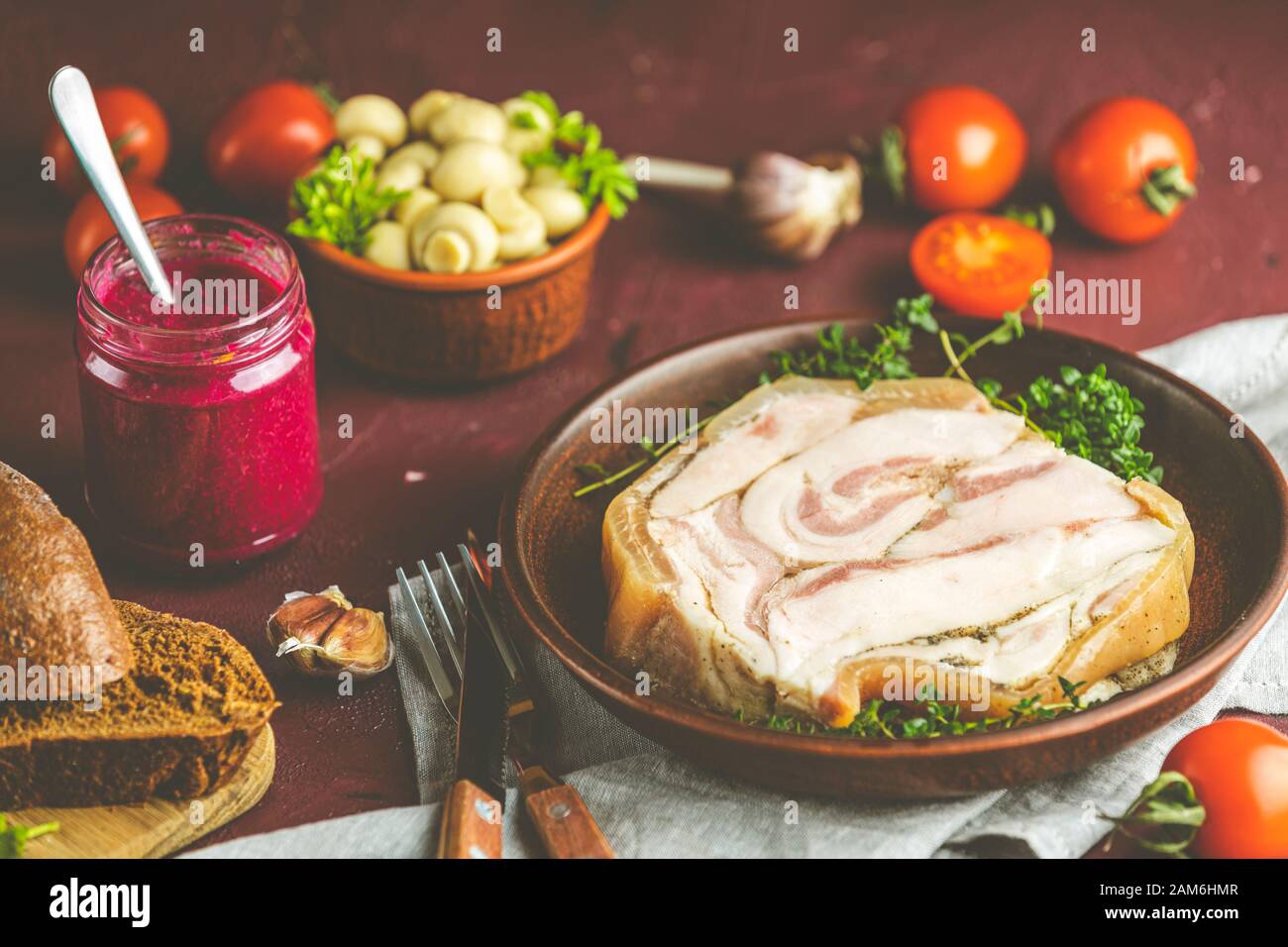 Baking pork lard bacon fatback with black pepper and other herbs and spices in ceramic dish. Traditional Ukrainian, Hungarian, Polish or other Eastern Stock Photo