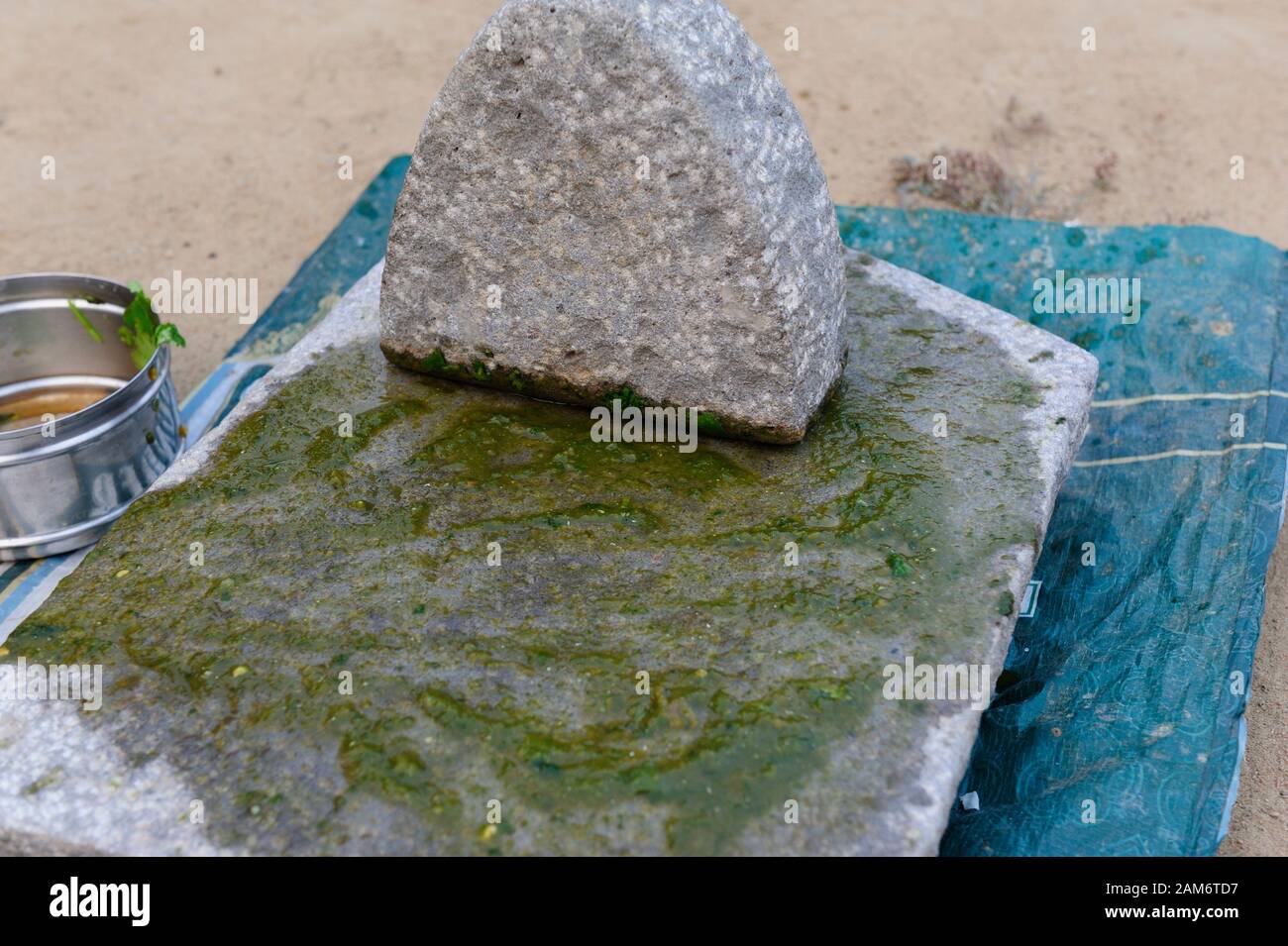 Grainte mortar and pestle and green pesto Stock Photo Alamy