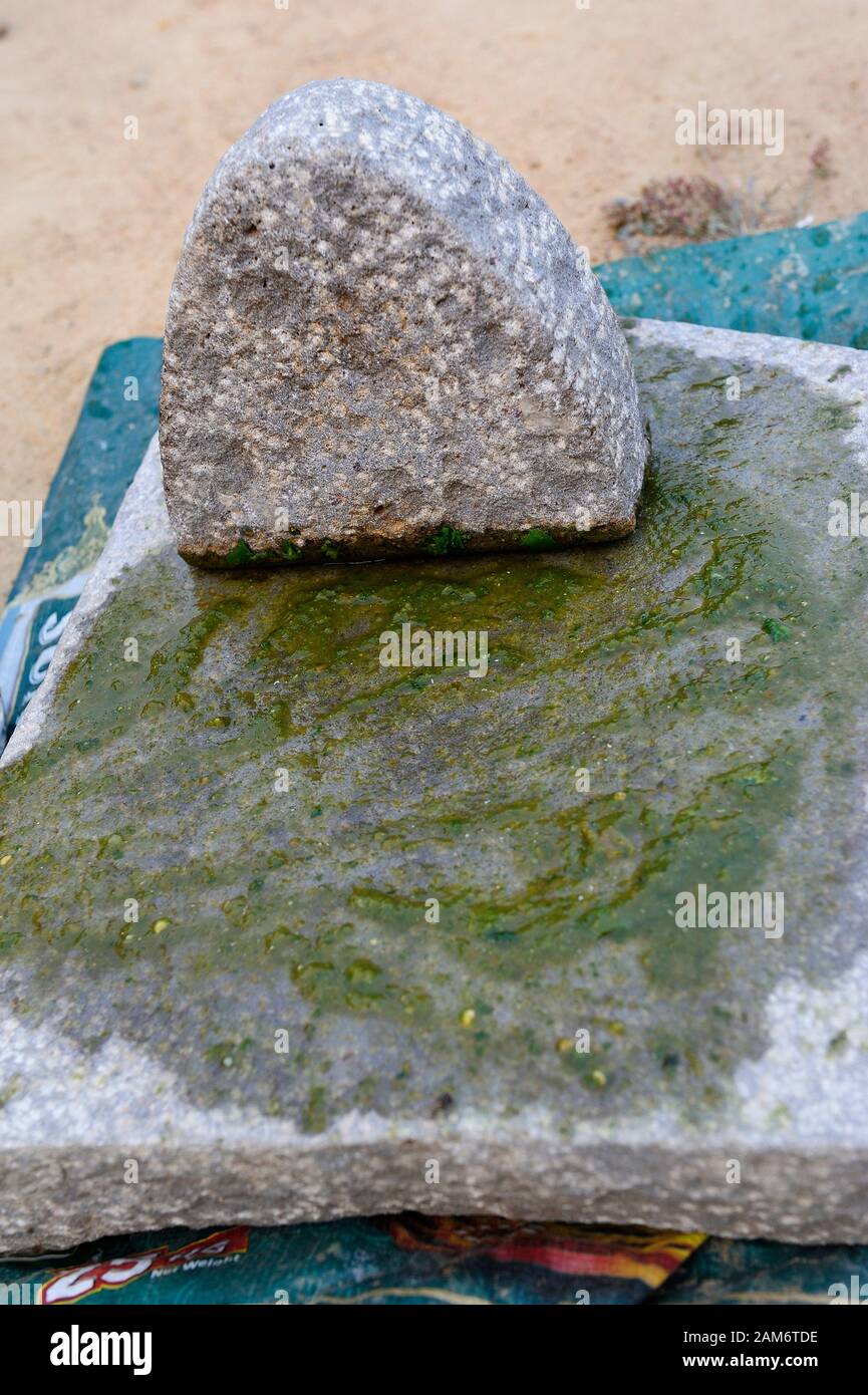 Grainte mortar and pestle and green pesto Stock Photo