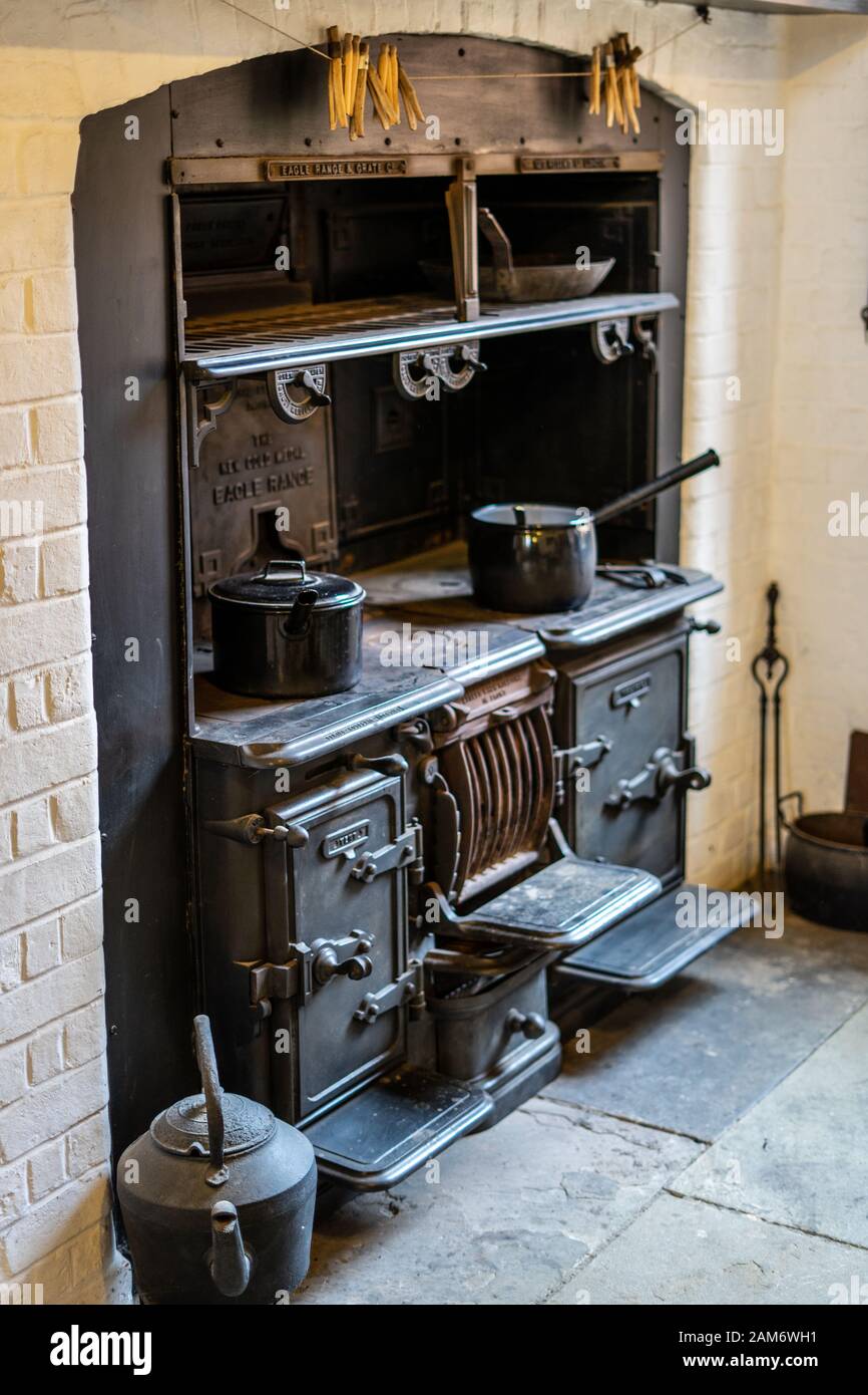 an old wood burning stove in a kitchen with pots and pans on top Stock  Photo - Alamy