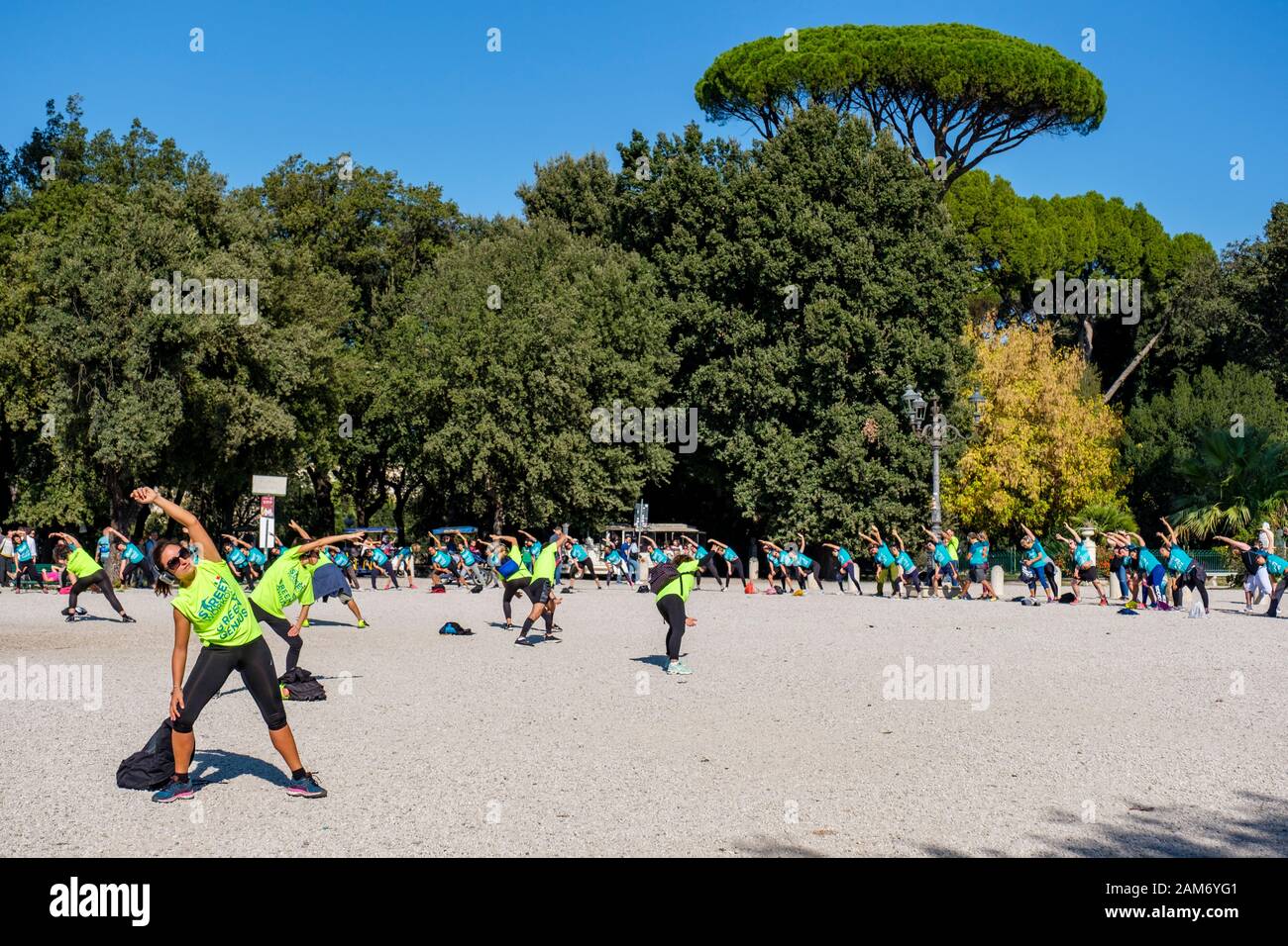 Street Workout Green Genius, group of people exercising outdoors at Terraza del Pincio, Villa Borghese city park, Rome, Italy Stock Photo