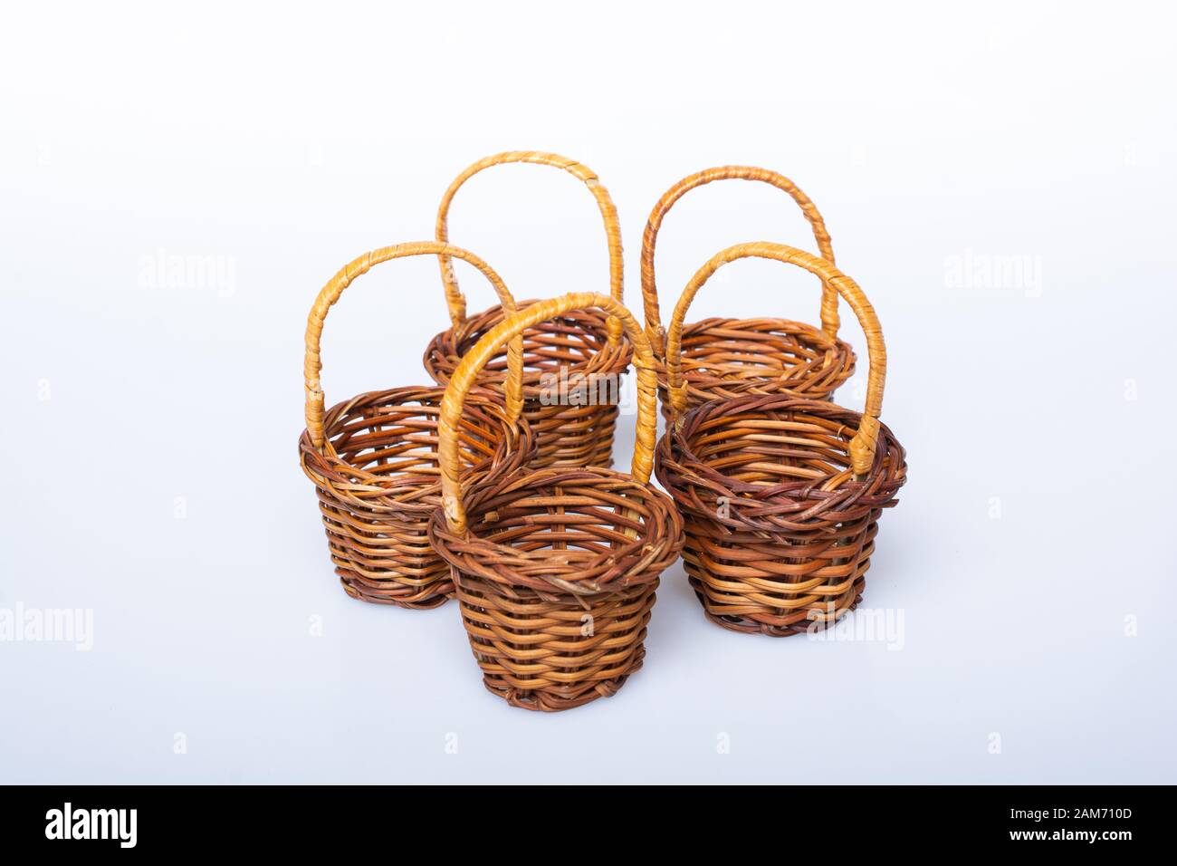 Little size Empty wicker baskets on white background Stock Photo - Alamy