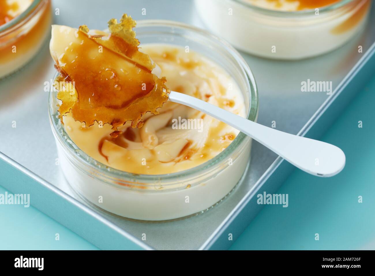 Closeup view of a portion of creme brulee dessert topped with caramelized sugar Stock Photo