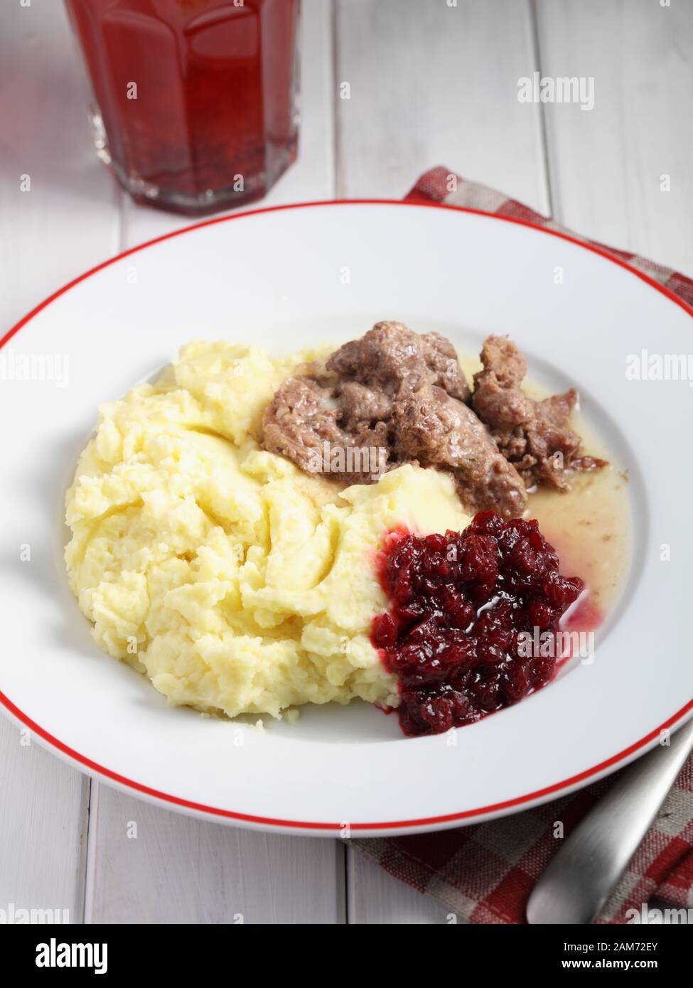 Finnish dinner with venison meat, mashed potato and lingonberry jam Stock Photo