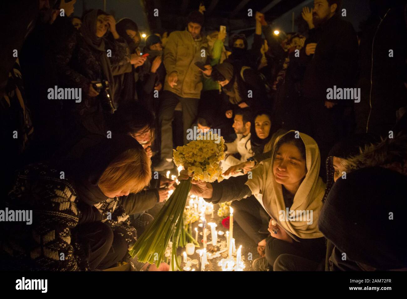 Tehran, Iran. 11th Jan, 2020. Iranians light candles for victims of Ukraine International Airlines Boeing 737-800 during as they protest in front of the Amir Kabir University in downtown Tehran, Iran. Media reported that hundreds of Iranians protest in Tehran in solidarity with victims of the Ukraine plane as the Iranian military released a statement claiming that Ukraine International Airlines flight PS752 was shot down due to human error. Credit: Rouzbeh Fouladi/ZUMA Wire/Alamy Live News Stock Photo