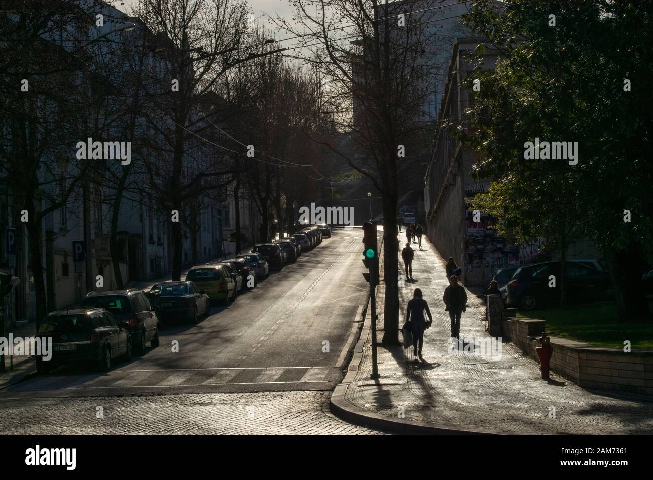 People walk up the street towards Coimbra University from the Praca da Republica in Coimbra Portugal Stock Photo