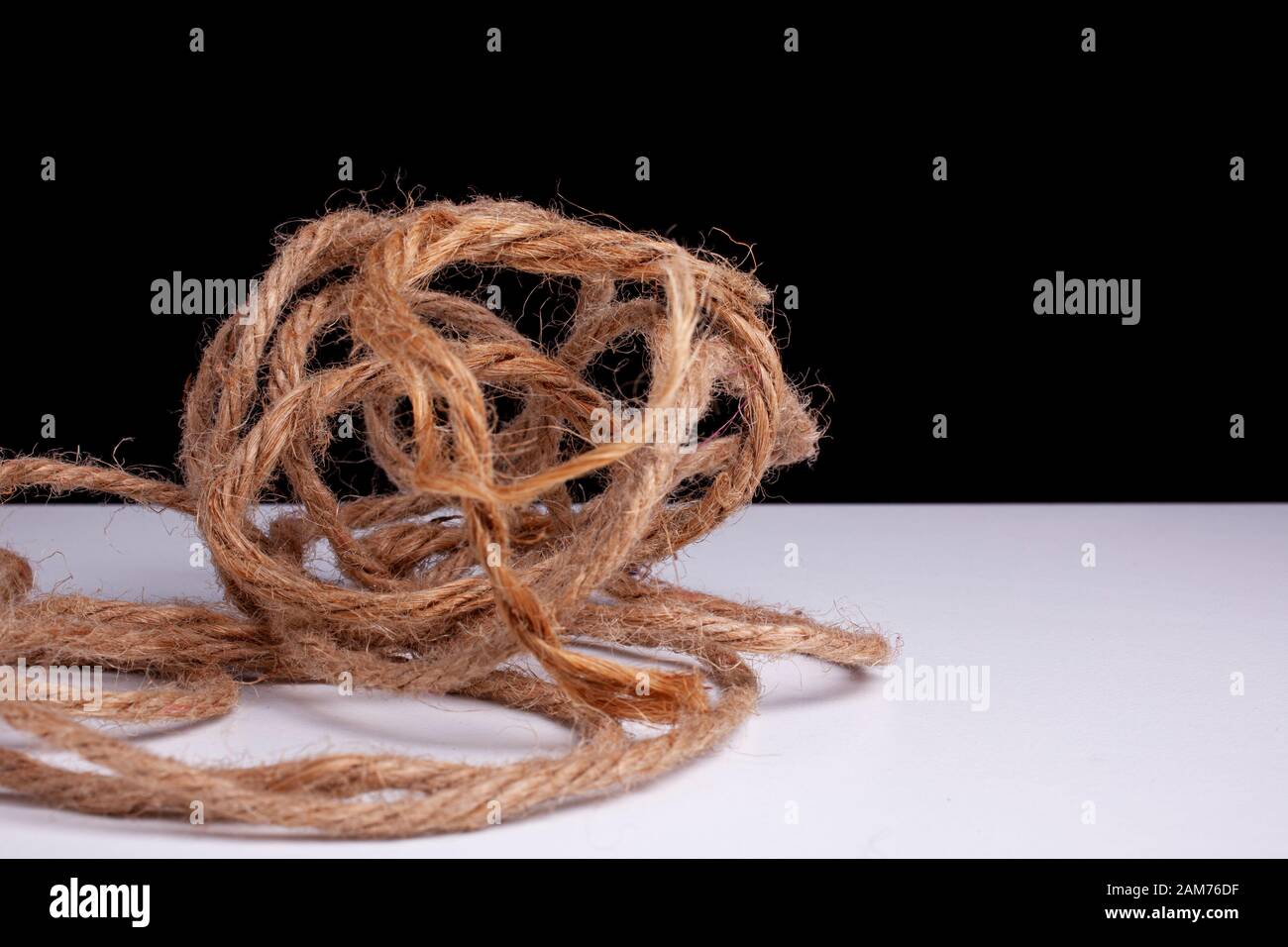 Unorganized mess. Tangled, stress, confused, complicated, concept image. Large ball of tangled and hemp string Stock Photo