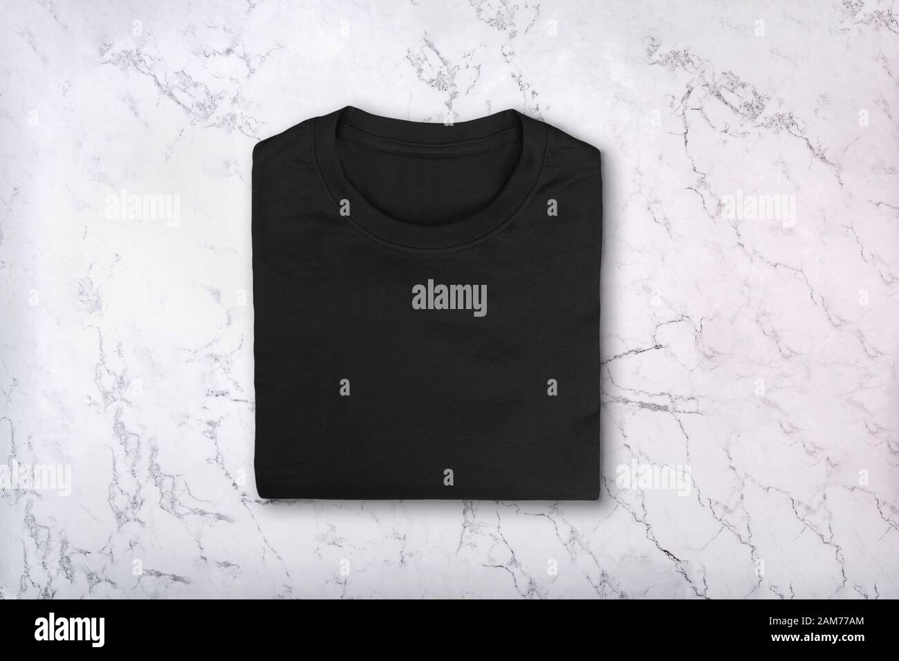 Blank black cotton t-shirt on marble texture Stock Photo
