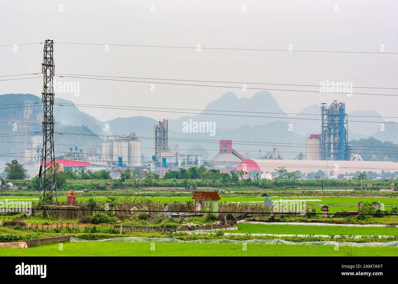 Industrial limestone quarry with rice paddy fields and ancestral graves, Ninh Binh, Vietnam, Asia Stock Photo