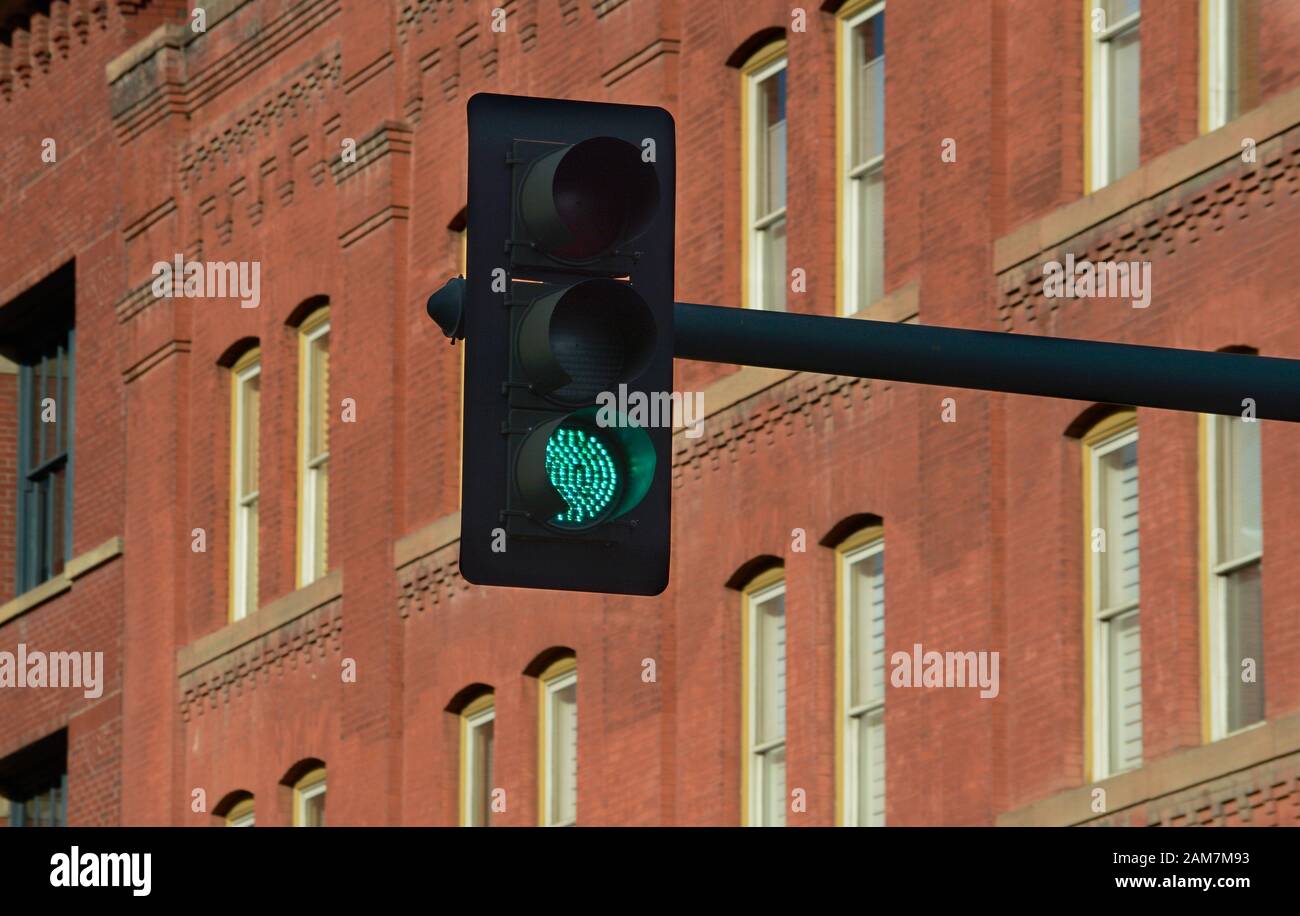 A traffic light at an intersection in downtown Denver, Colorado, signals a green light to motorists. Stock Photo