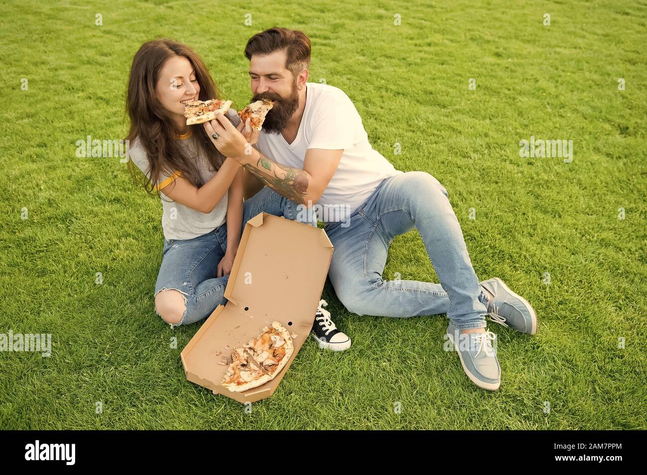 Try This. Summer Picnic On Green Grass. Couple In Love Dating. Fast Food. Bearded Man Hipster And Adorable Girl Eat Pizza. Family Weekend. Happy Couple Eating Pizza. Loving Couple Enjoy Yummy Pizza