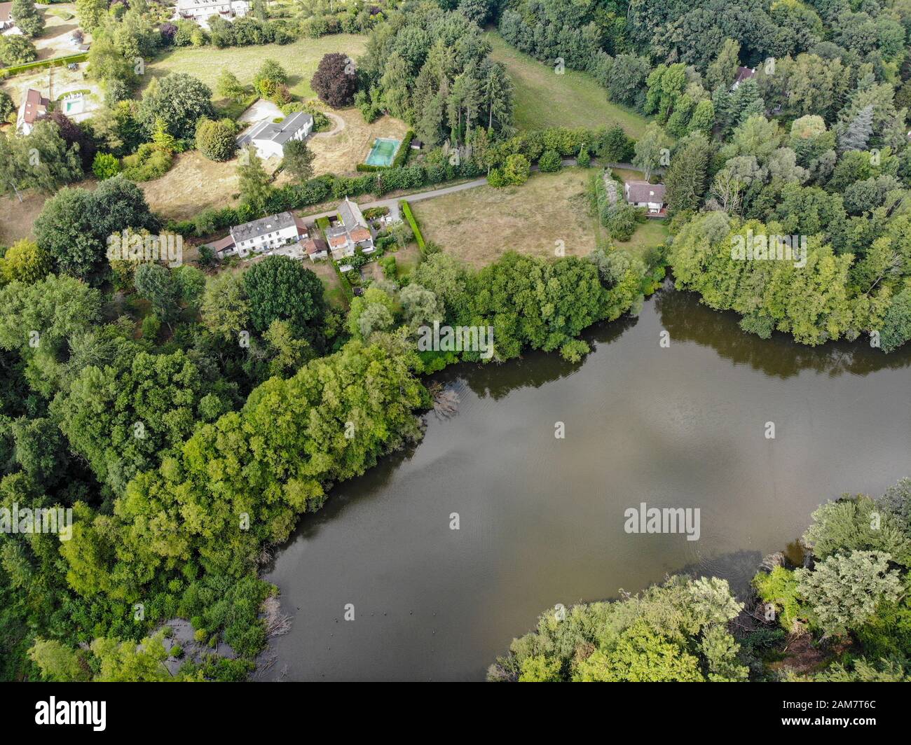 Aerial top view of country side landscape with forest and lake, Bousval ...