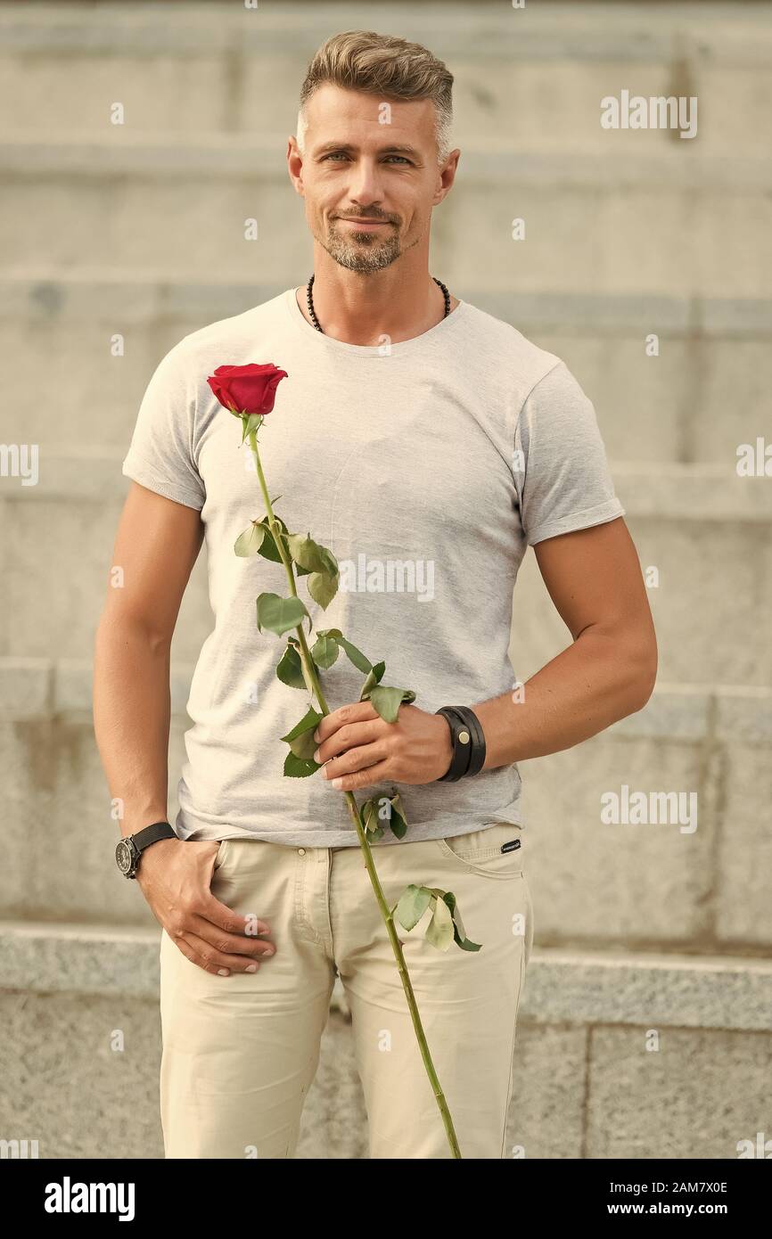 Happy Womens Day To All The Lovely Women Bearded Man Holding Womens Day Flower In Spring Handsome Man With Red Rose For Womens Day Celebrating March 8 Or International Womens Holiday Stock