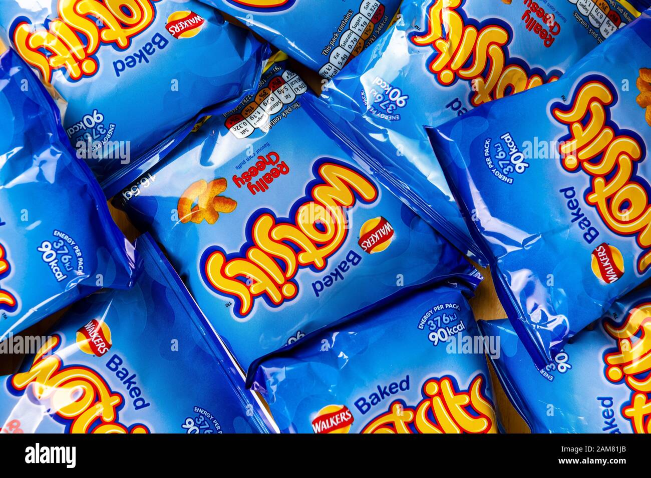 Bags of walkers baked wotsits cheesy potato puffs spread out on a table