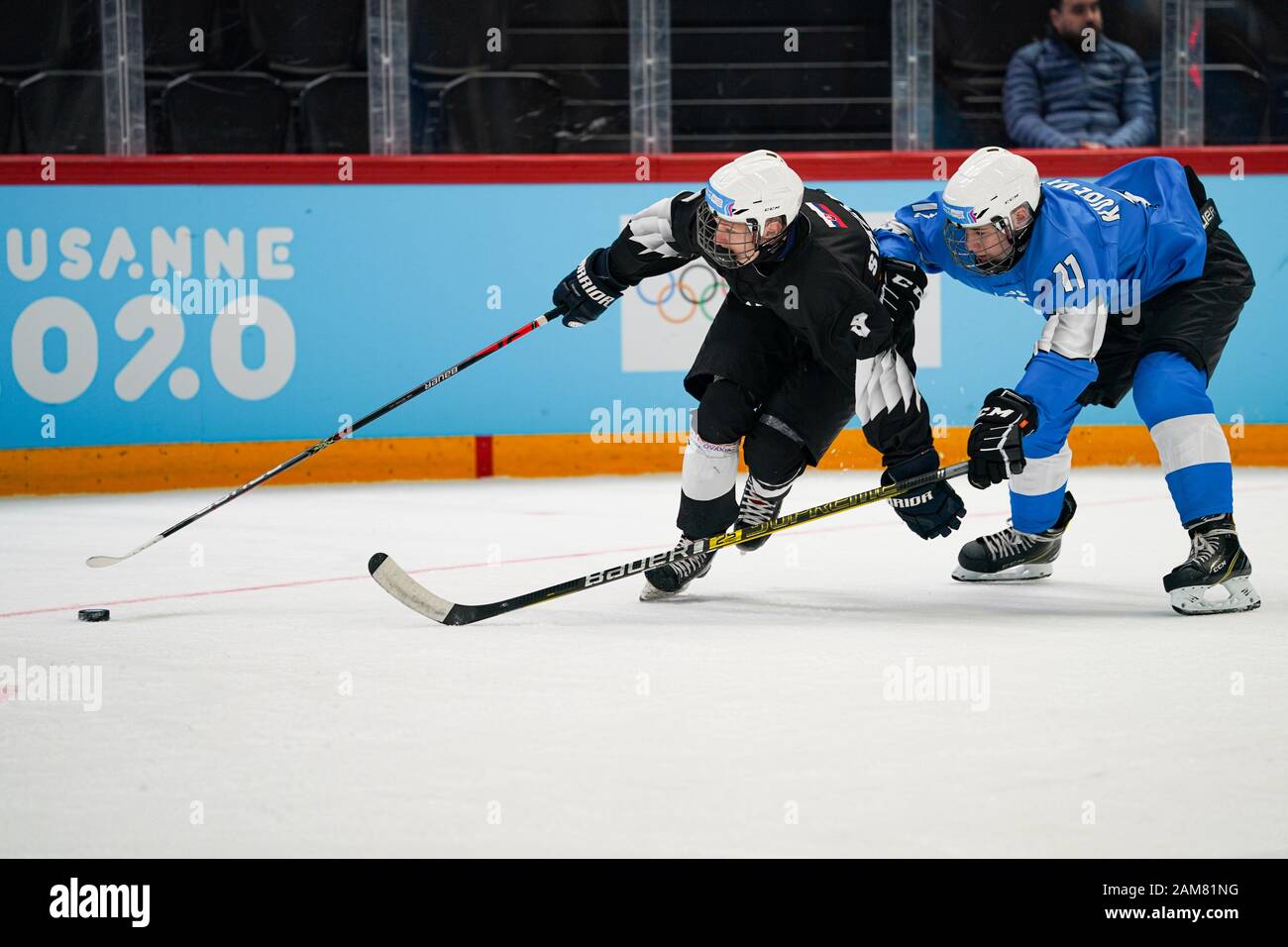 Lausanne, Switzerland. 11th Jan, 2020. Adam Sykora (L) from Slovakia of Black team competes with Konrad Kudeviita from Estonia of Blue team during the men's mixed ice hockey 3-on-3 preliminary round Game 9 between Blue team and Black team at the Lausanne 2020 Winter Youth Olympic Games (YOG) in Lausanne, Switzerland, Jan. 11, 2020. Credit: Bai Xueqi/Xinhua/Alamy Live News Stock Photo