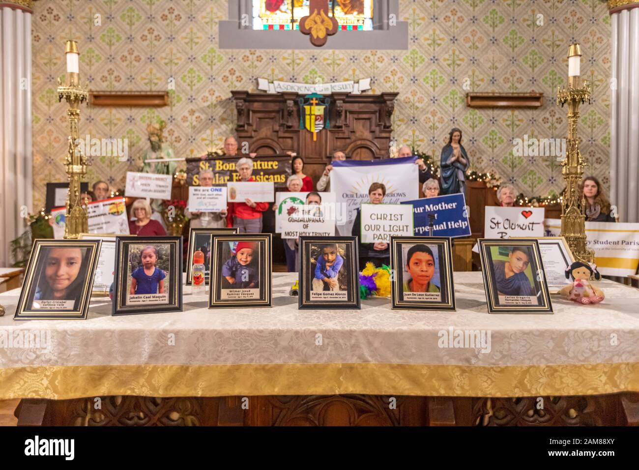 Detroit, Michigan, USA. 11th Jan, 2020. A 'Holy Hour' at Most Holy Trinity Catholic Church supported refugees fleeing violence in their home countries. Photographs of children who died while in U.S. custody after crossing the border were placed on the altar. The event was organized by Strangers No Longer during the U.S. Catholic Bishops' National Migration Week. Credit: Jim West/Alamy Live News Stock Photo