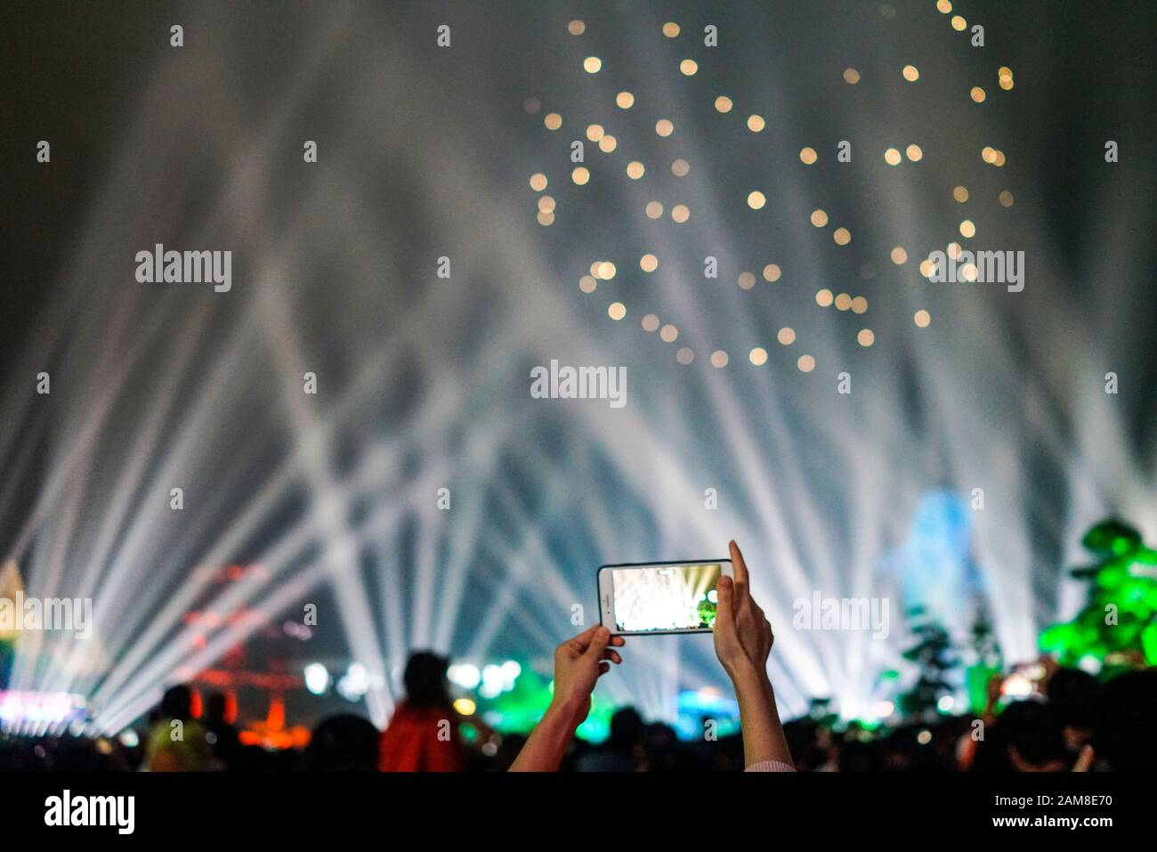 Zhuhai, China, November, 2018. People are using mobile phones to record light shows at Chimelong Ocean Kingdom. Chimelong is a theme park resort locat Stock Photo