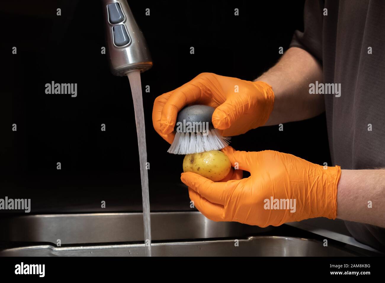 Close up of washing and rinsing potatoes in preparation for cooking
