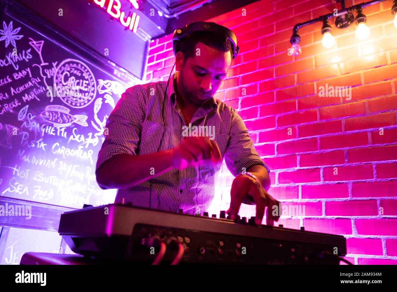 Male DJ playing music in club Stock Photo
