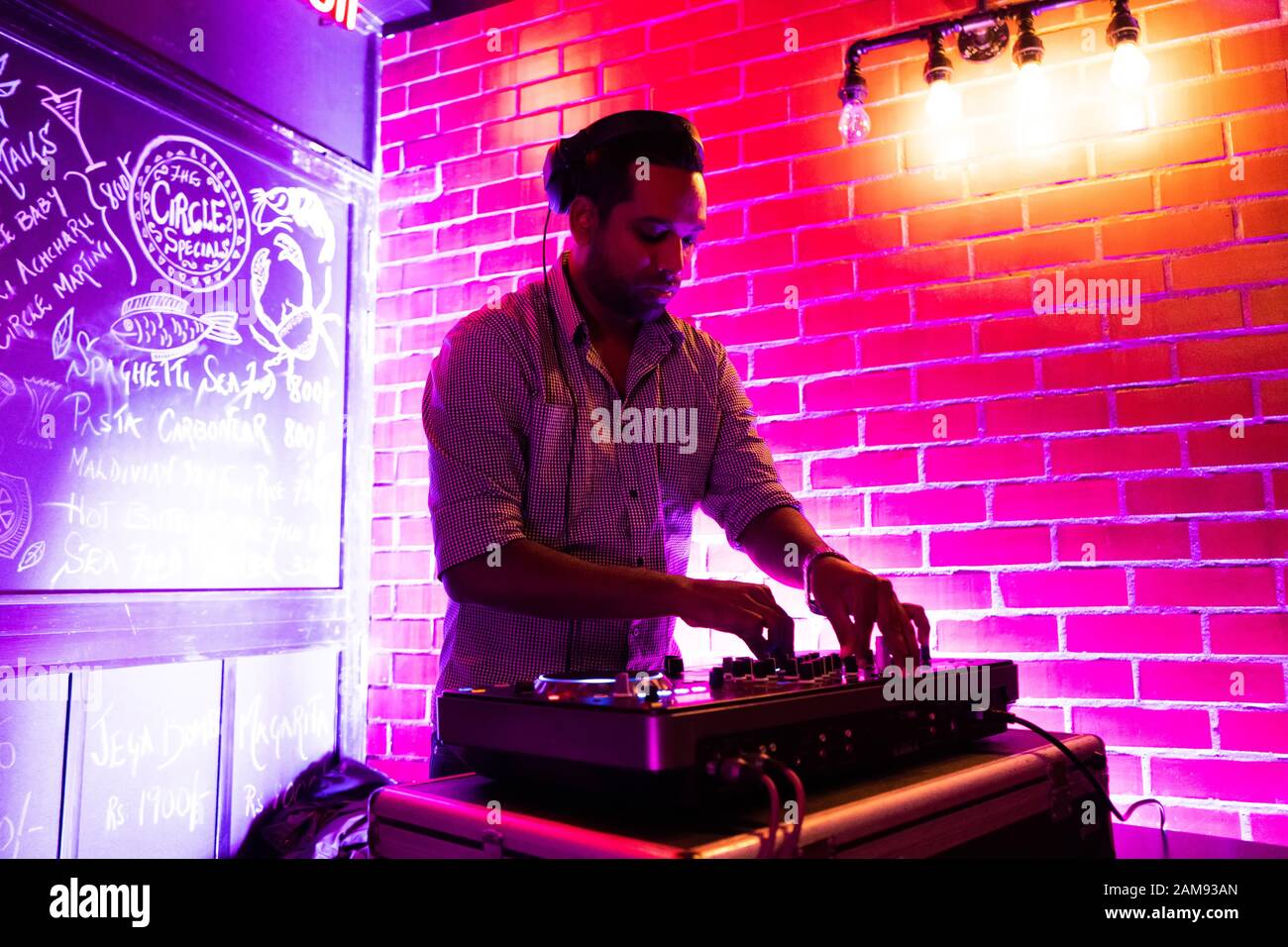 Male DJ playing music in club Stock Photo