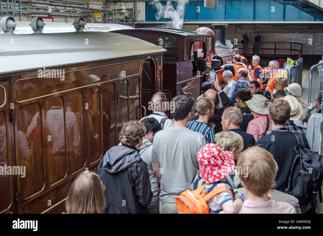 London, UK - June 22, 2019: Crowds admiring the last steam train to use the District Line to arrive at Ealing Broadway Station.  The special event mar Stock Photo