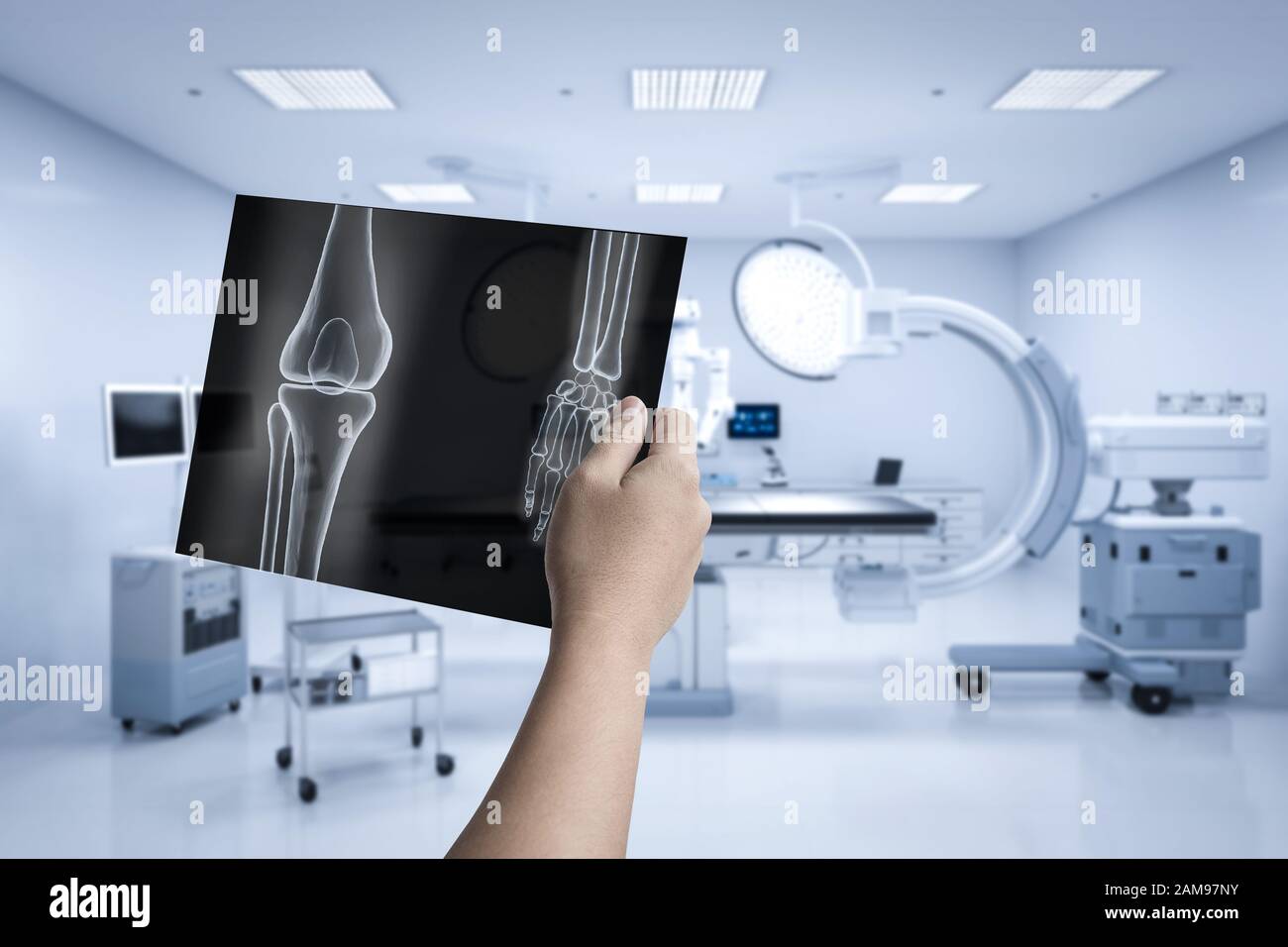 Hand holding x-ray film with 3d rendering mri scan machine or magnetic resonance imaging scan device Stock Photo