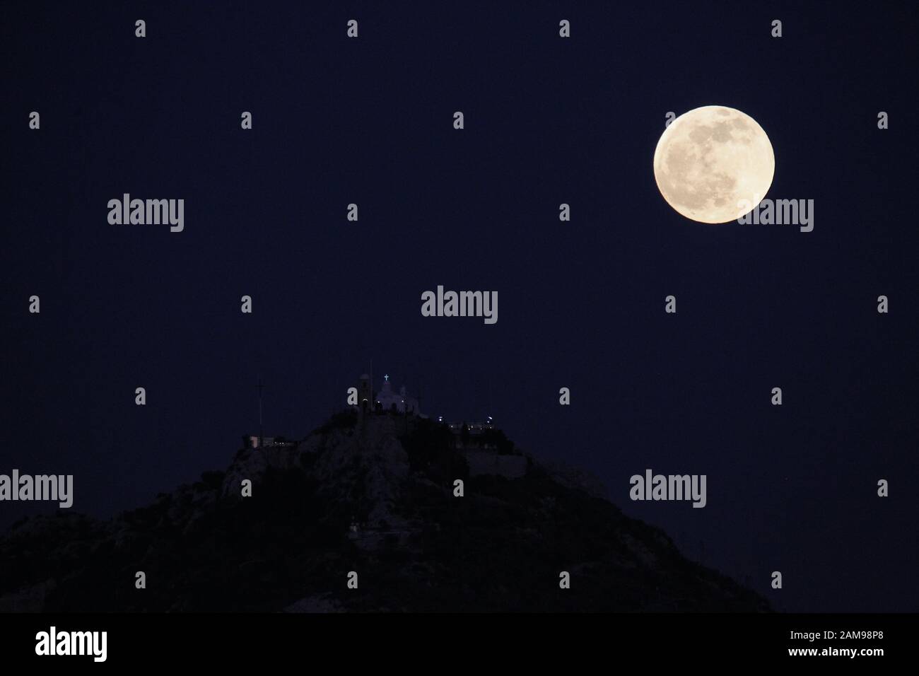 The Wolf Moon Rises Above Lycabetus Hill In Athens The First Full Moon Of 2020 Also Known As The Wolf Moon Coincides With A Lunar Eclipse Stock Photo Alamy