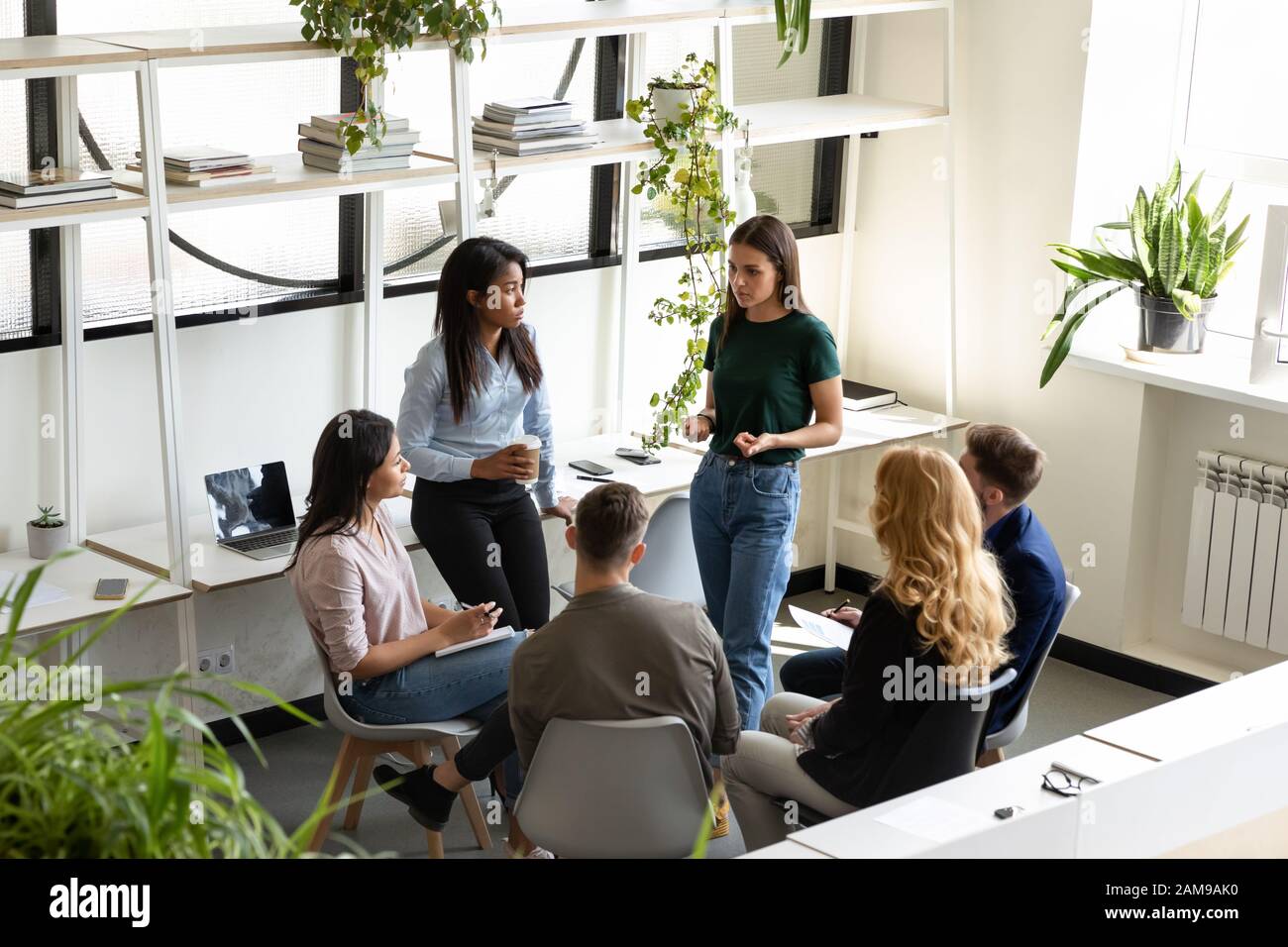 Concerned diverse office employees gather together solve business problems Stock Photo