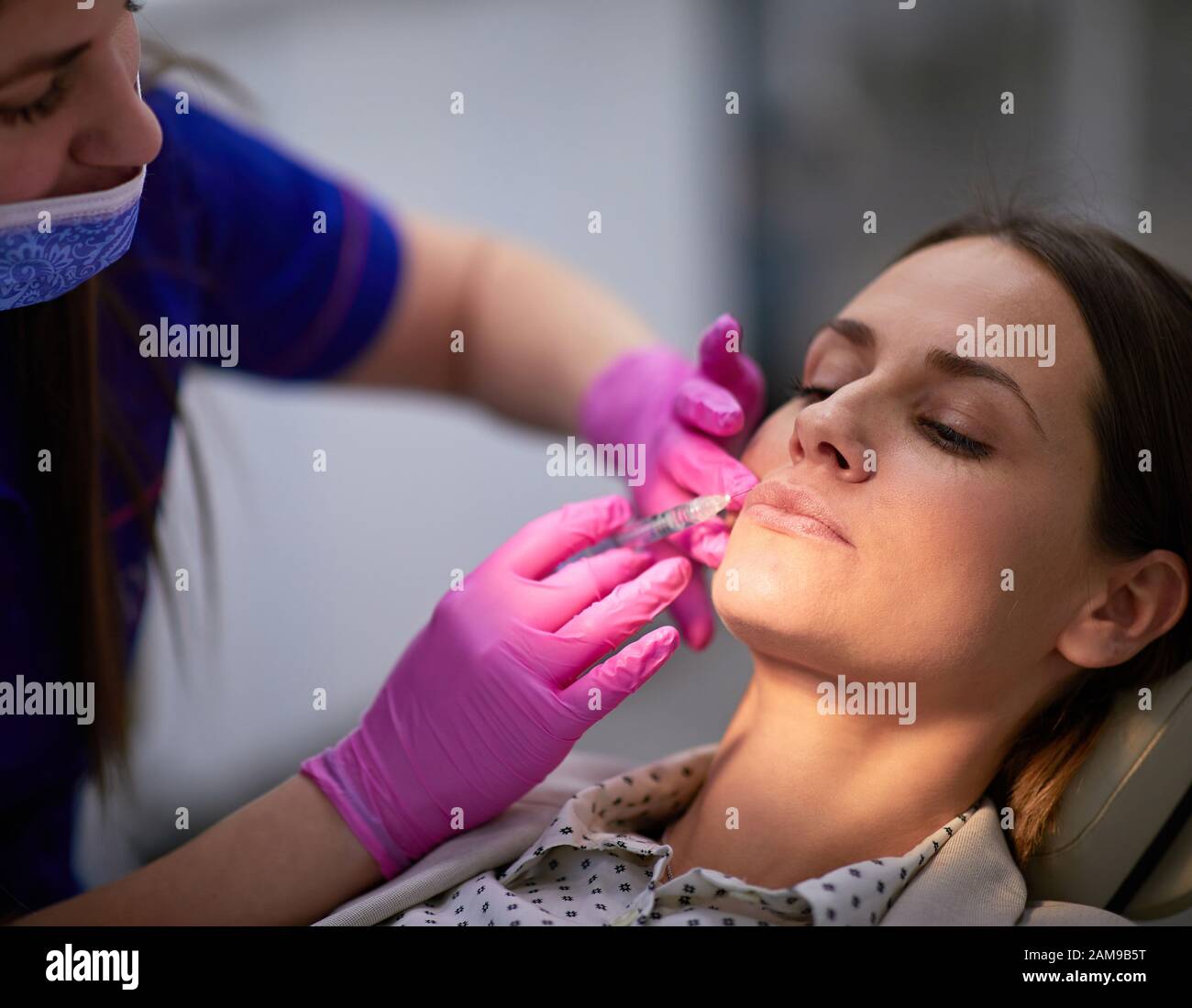 Woman having lip treatment for the elevation of mouth corners and