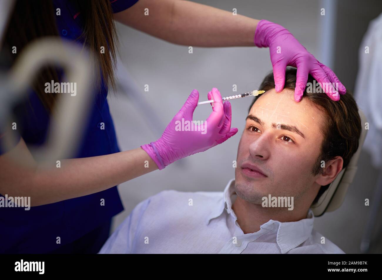 Man having a medical wrinkle treatment with botulinum toxin injection Stock Photo