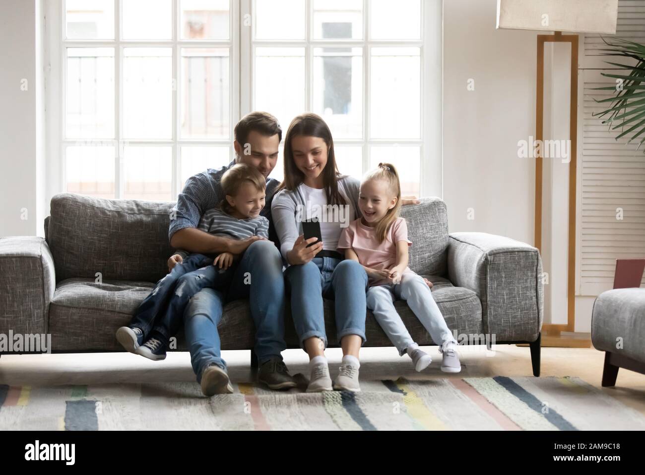 Hooked on Phone. Family Play Mobile Phone Game at Home. Staying Connected  with Cell Phone. Family Communication Stock Photo - Image of beard, baby:  180857330