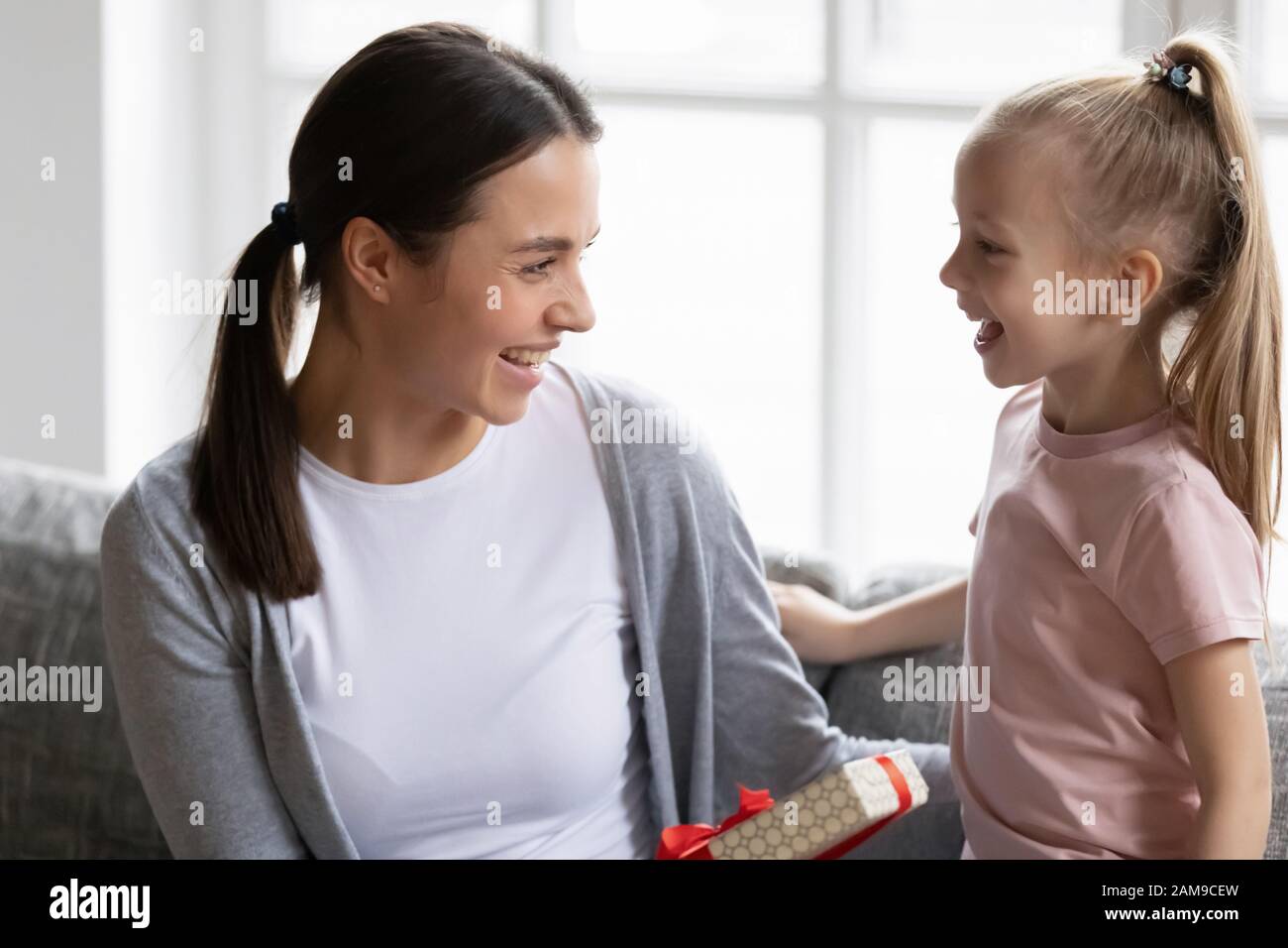 Happy little girl congratulate young mother with birthday Stock Photo