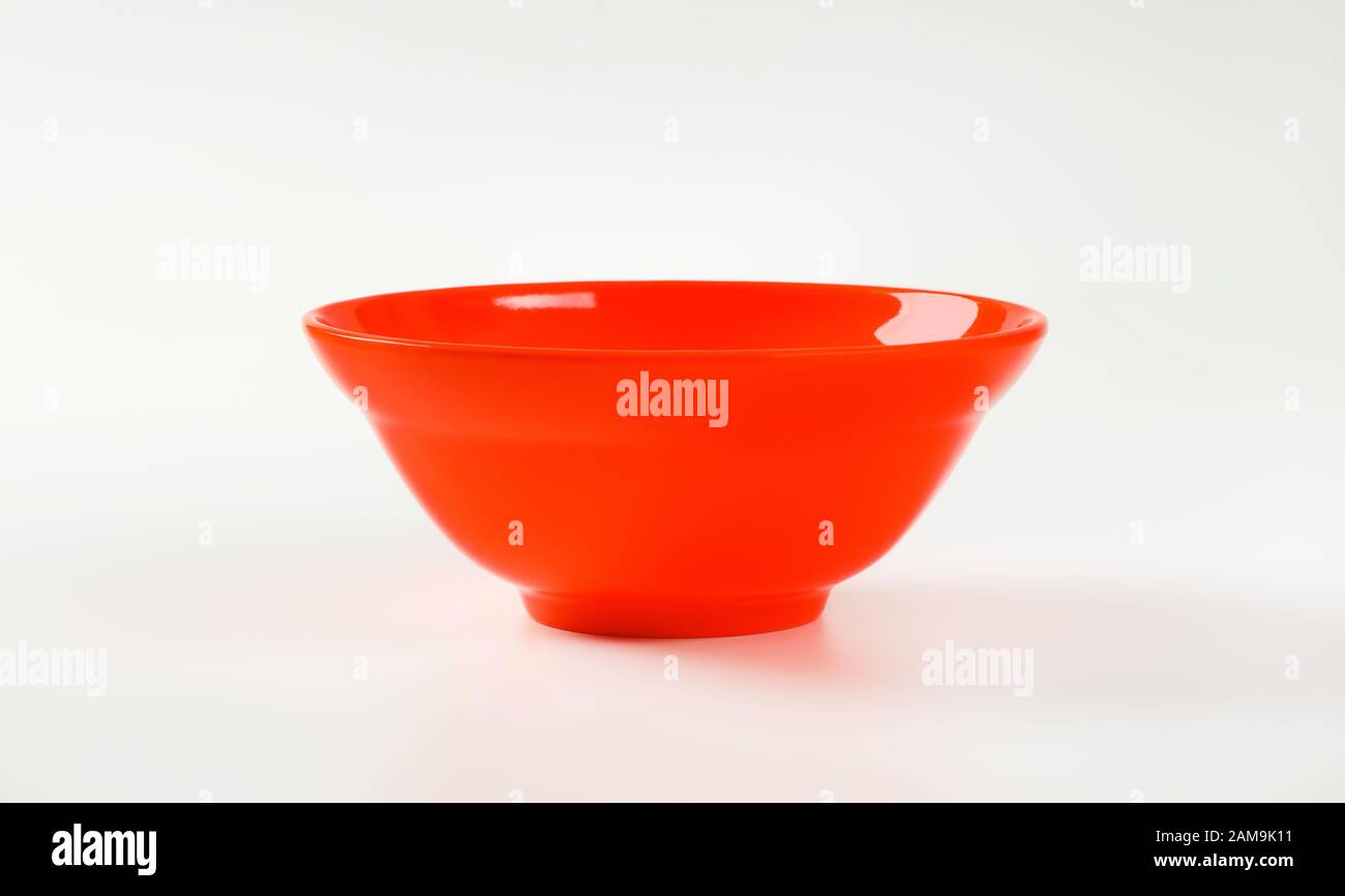 Empty deep red plastic bowl Stock Photo