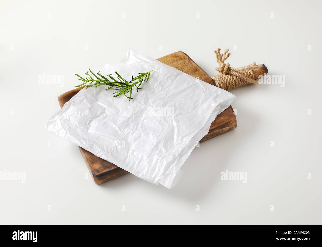 https://c8.alamy.com/comp/2AM9K3G/creased-sheet-of-white-wax-paper-and-fresh-rosemary-on-cutting-board-2AM9K3G.jpg