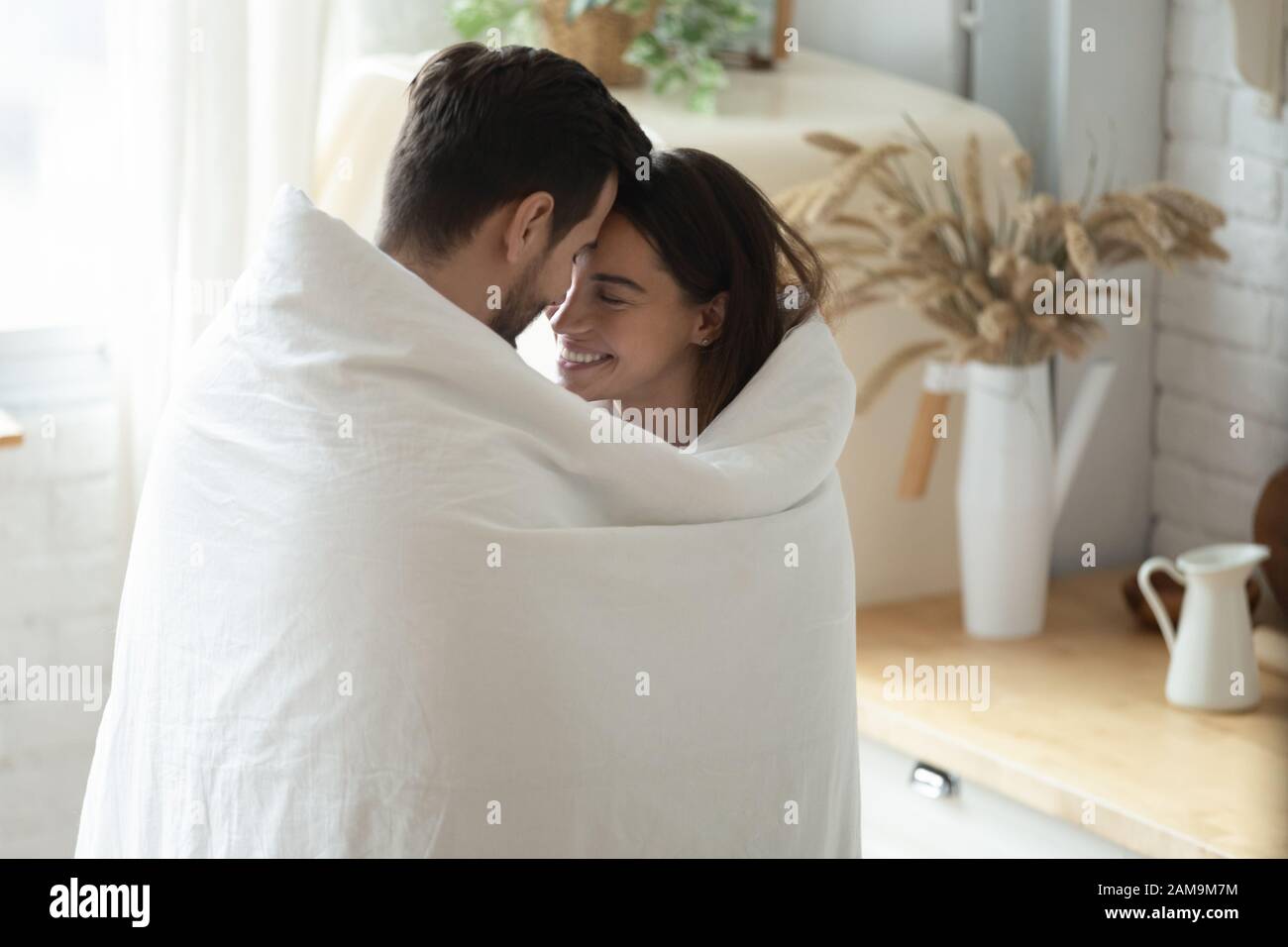 Happy married family couple enjoying sweet tender morning moment. Stock Photo