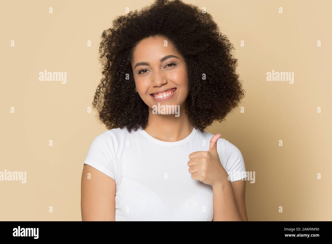 Young african american lady showing like, thumbs up gesture. Stock Photo