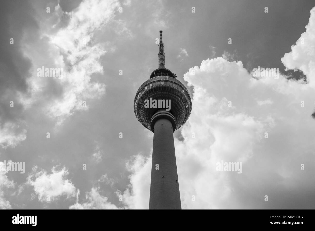 The detail of the famous TV tower in Berlin, one of the main sights of the city. Pictured against the cloudy sky in big contrast. Stock Photo