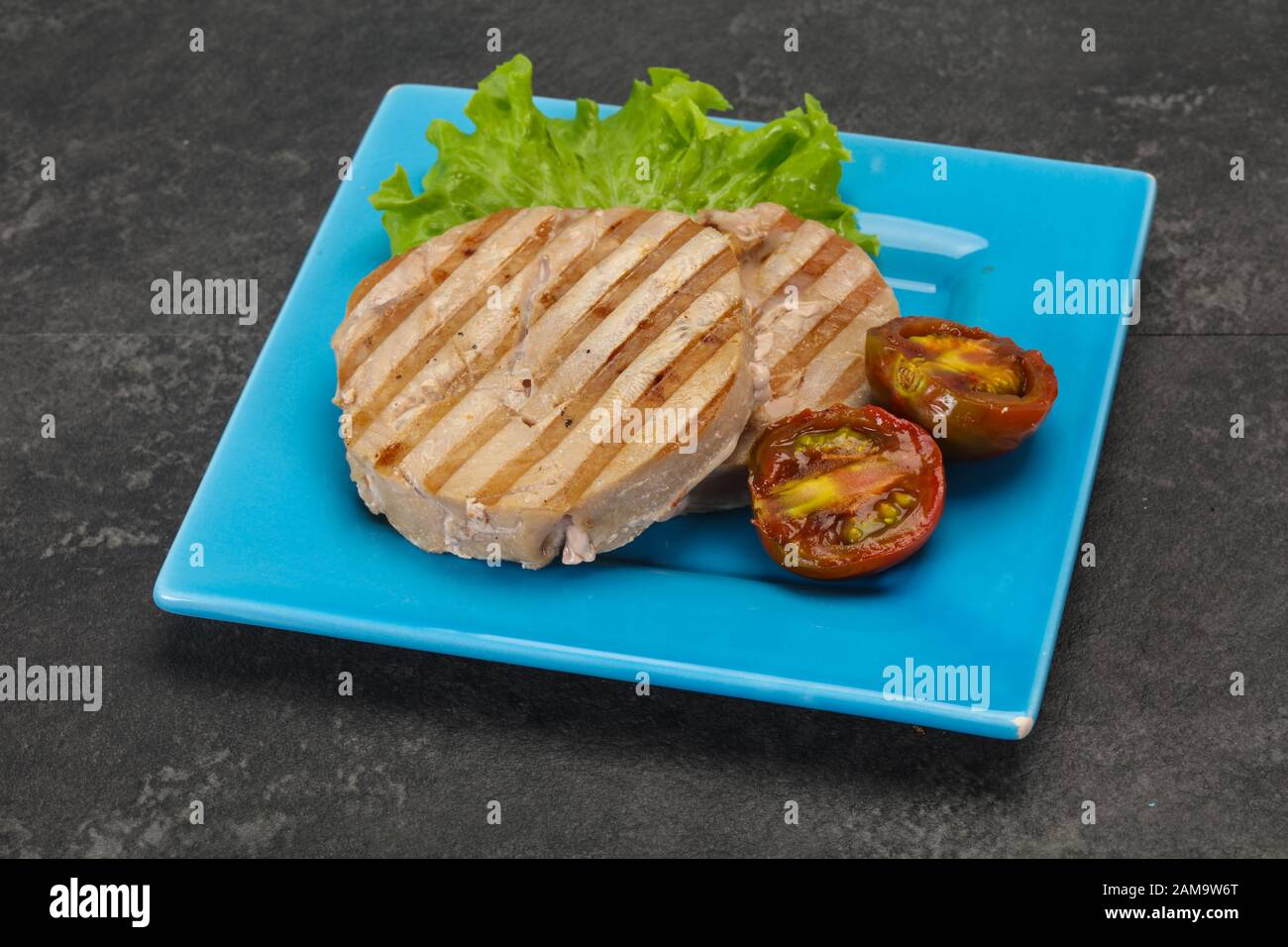 Grilled tuna steak with kumato and salad Stock Photo Alamy