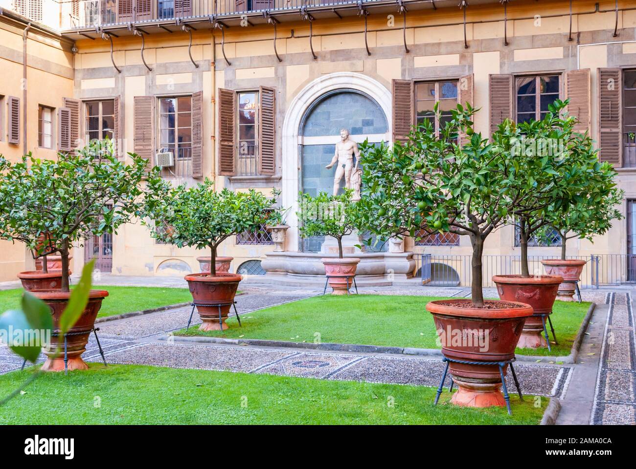 Outer courtyard of the Medici Riccardi Palace, which has an Italian garden with statues and tubs with plants. Florence, Italy Stock Photo