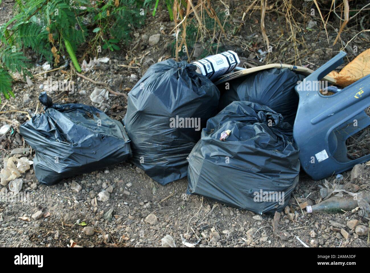 Premium Photo  A large black garbage bag on the side of the road