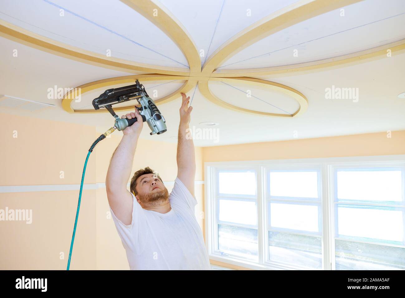 Installing ceiling moldings in the interior handyman using gauge finish ...