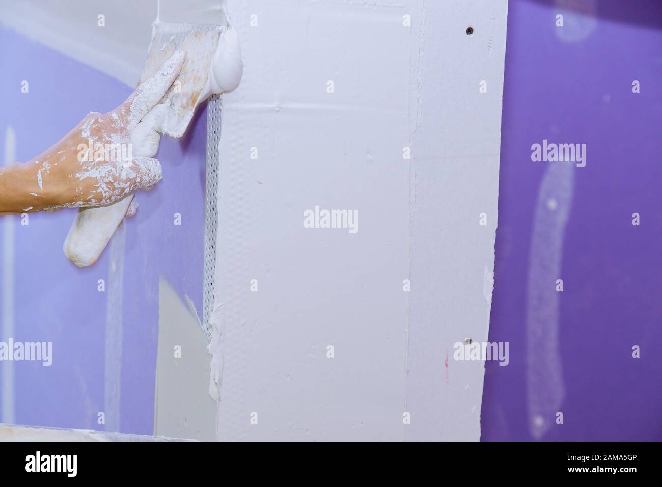 Construction worker plastering the wall, skim coating plaster walls Stock Photo Alamy