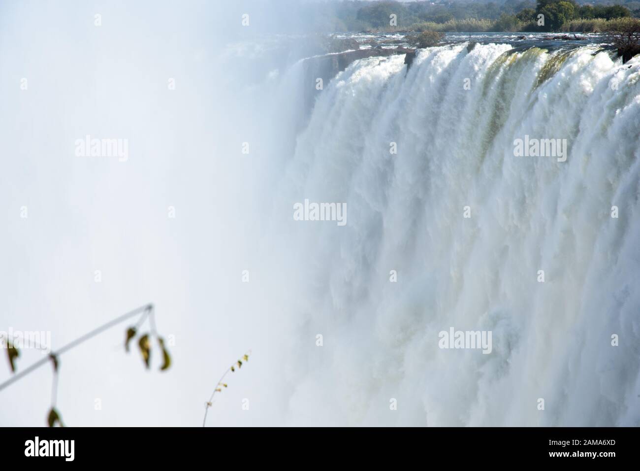 View of Victoria Falls from the Zambian side of the Zambezi river, with rising mist Stock Photo