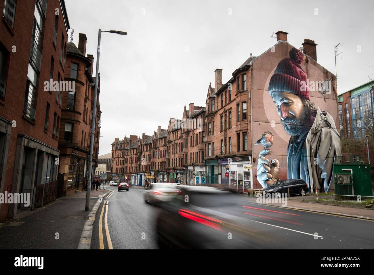 One of Glasgow's best-known murals, by street artist Smug, depicts a modern-day St Mungo which references the story of the Bird That Never Flew. January 13 is the feast day of St Mungo who is the patron saint and founder of the City of Glasgow. Stock Photo